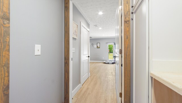 241 Mullet Dr, Freeport, FL 32439 - hallway with light wood-style floors, baseboards, recessed lighting, crown molding, and a textured ceiling