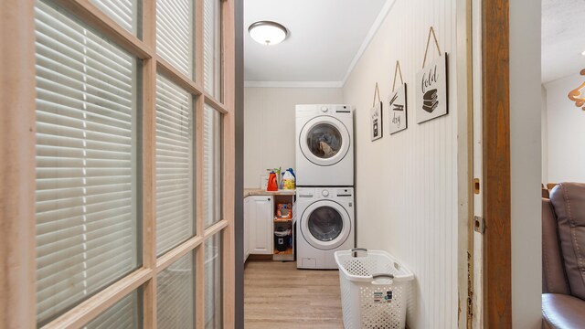 241 Mullet Dr, Freeport, FL 32439 - laundry area featuring estacked washer and dryer, ornamental molding, and light wood-type flooring