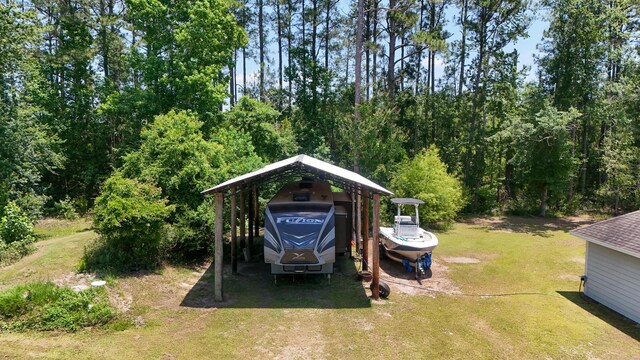 241 Mullet Dr, Freeport, FL 32439 - view of grassy yard featuring a detached carport and driveway