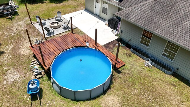 241 Mullet Dr, Freeport, FL 32439 - view of pool with an outdoor fire pit, a wooden deck, and a patio