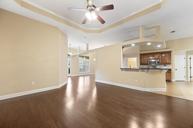 201 Pinque Coat Ct, Crestview, FL 32536 - unfurnished living room with wood-type flooring, ceiling fan, and ornamental molding