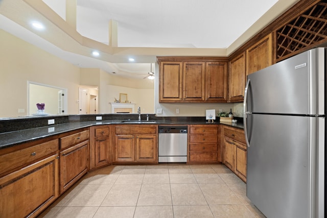 201 Pinque Coat Ct, Crestview, FL 32536 - kitchen with appliances with stainless steel finishes, brown cabinetry, light tile patterned floors, dark stone counters, and recessed lighting