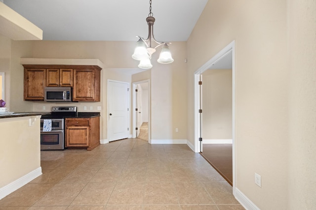 201 Pinque Coat Ct, Crestview, FL 32536 - kitchen with appliances with stainless steel finishes, a chandelier, brown cabinets, light tile patterned floors, and hanging light fixtures