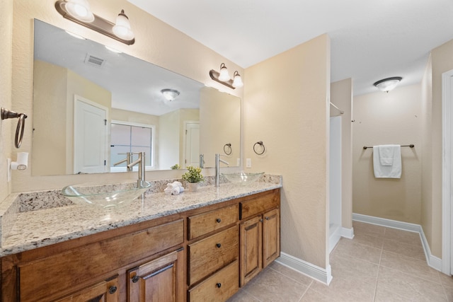 201 Pinque Coat Ct, Crestview, FL 32536 - bathroom with double vanity, a walk in shower, and tile patterned flooring