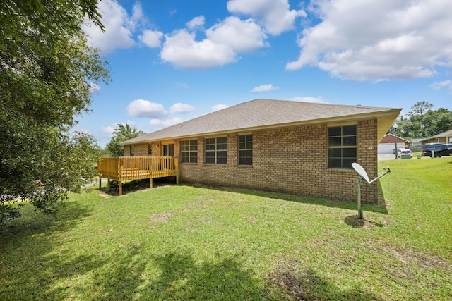 201 Pinque Coat Ct, Crestview, FL 32536 - back of property featuring a deck, a lawn, and brick siding