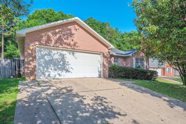 407 Tobago Ct, Crestview, FL 32536 - view of front of home featuring brick siding, a garage, and driveway