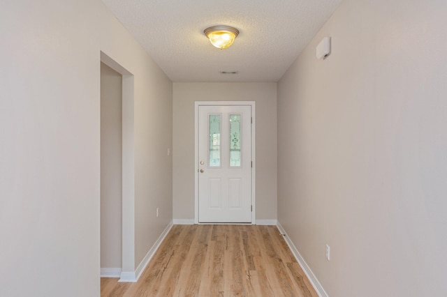 407 Tobago Ct, Crestview, FL 32536 - entryway featuring a textured ceiling, light wood-style floors, and baseboards