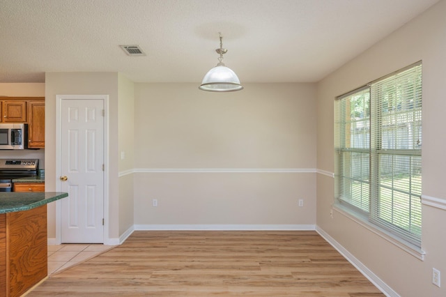 407 Tobago Ct, Crestview, FL 32536 - unfurnished dining area featuring light wood-type flooring and baseboards