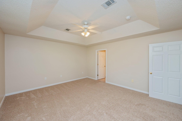 407 Tobago Ct, Crestview, FL 32536 - unfurnished bedroom featuring a raised ceiling, light colored carpet, baseboards, a textured ceiling, and ceiling fan