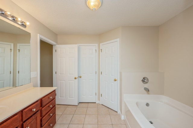 407 Tobago Ct, Crestview, FL 32536 - full bathroom with a garden tub, vanity, tile patterned flooring, and a textured ceiling