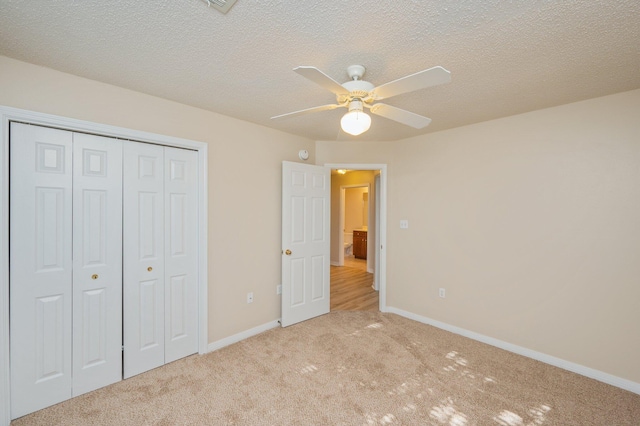 407 Tobago Ct, Crestview, FL 32536 - unfurnished bedroom with light colored carpet, a closet, baseboards, ceiling fan, and a textured ceiling
