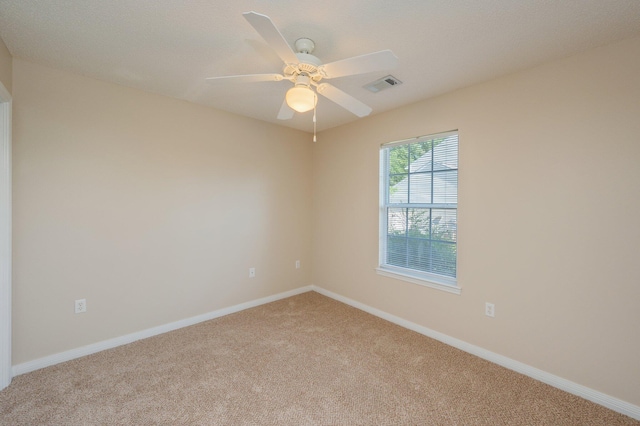 407 Tobago Ct, Crestview, FL 32536 - spare room featuring light carpet, baseboards, and ceiling fan