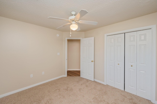 407 Tobago Ct, Crestview, FL 32536 - unfurnished bedroom featuring carpet flooring, a closet, baseboards, ceiling fan, and a textured ceiling