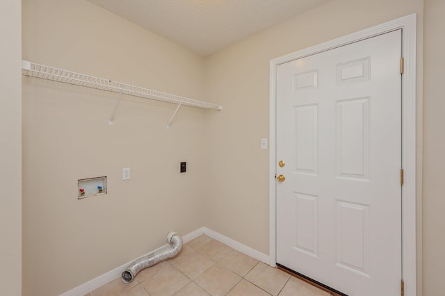 407 Tobago Ct, Crestview, FL 32536 - laundry area featuring electric dryer hookup, washer hookup, baseboards, light tile patterned flooring, and a textured ceiling