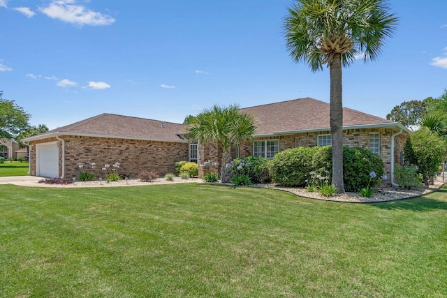 2741 Creeks Edge Ln, Navarre, FL 32566 - ranch-style home with a front lawn, an attached garage, brick siding, a shingled roof, and concrete driveway