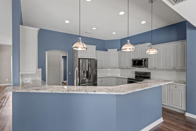 2741 Creeks Edge Ln, Navarre, FL 32566 - kitchen featuring stainless steel appliances, decorative backsplash, a peninsula, dark wood-type flooring, and recessed lighting