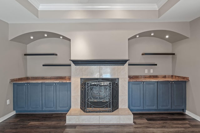 2741 Creeks Edge Ln, Navarre, FL 32566 - unfurnished living room with a tray ceiling, dark wood-type flooring, ornamental molding, baseboards, and a tiled fireplace