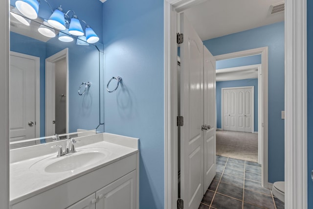 2741 Creeks Edge Ln, Navarre, FL 32566 - bathroom featuring vanity, toilet, tile patterned floors, and baseboards