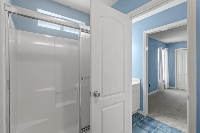 2741 Creeks Edge Ln, Navarre, FL 32566 - bathroom featuring a shower stall, tile patterned flooring, baseboards, and vanity