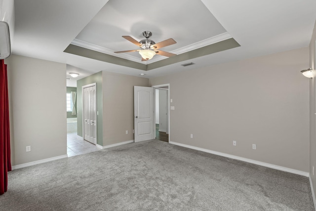 2741 Creeks Edge Ln, Navarre, FL 32566 - unfurnished bedroom with a raised ceiling, light colored carpet, crown molding, baseboards, and connected bathroom