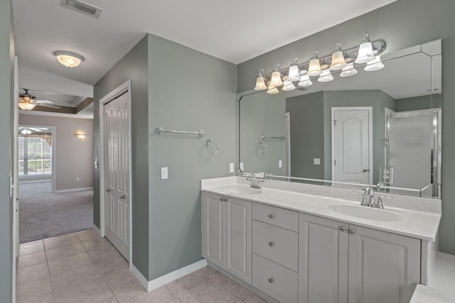 2741 Creeks Edge Ln, Navarre, FL 32566 - bathroom featuring double vanity, baseboards, tile patterned flooring, a ceiling fan, and an enclosed shower