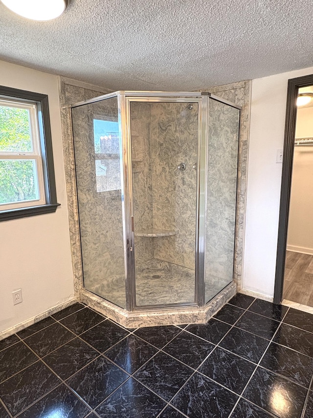 914 Georgia St, Crestview, FL 32536 - full bathroom with a textured ceiling, a shower stall, and baseboards