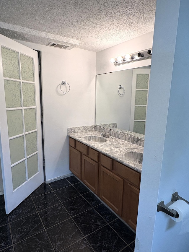 914 Georgia St, Crestview, FL 32536 - full bathroom with double vanity and a textured ceiling