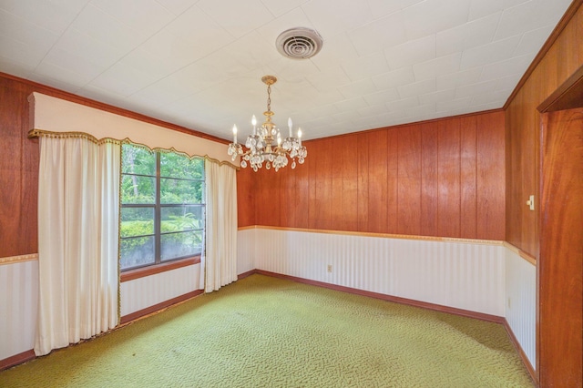2226 W James Lee Blvd, Crestview, FL 32536 - spare room featuring a chandelier, light carpet, and wooden walls