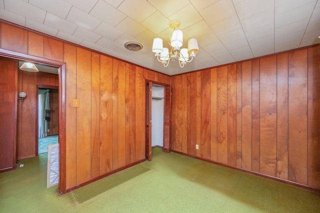 2226 W James Lee Blvd, Crestview, FL 32536 - unfurnished room featuring a chandelier, carpet floors, and wood walls