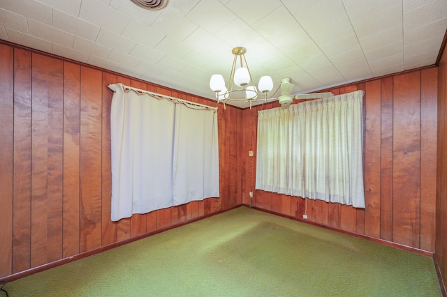 2226 W James Lee Blvd, Crestview, FL 32536 - carpeted empty room featuring a chandelier and wood walls