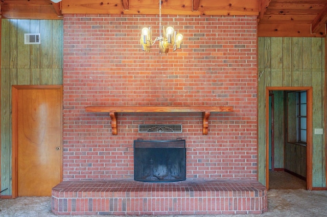 2226 W James Lee Blvd, Crestview, FL 32536 - unfurnished living room with carpet, wood walls, a brick fireplace, beamed ceiling, and a chandelier
