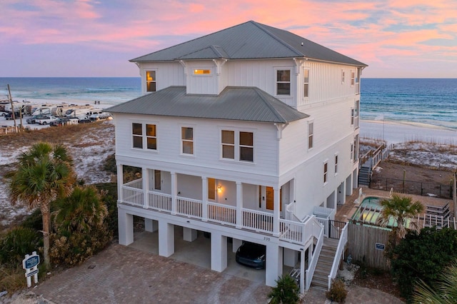 330 Tang O Mar Dr, Destin, FL 32550 - back of property at dusk featuring a carport, stairs, view of water and beach, and driveway
