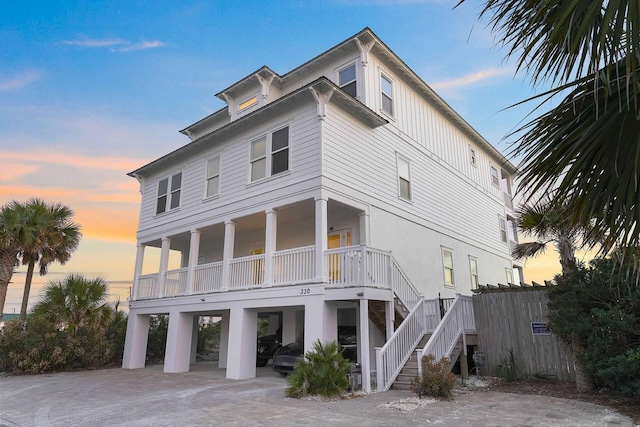 330 Tang O Mar Dr, Destin, FL 32550 - view of front facade with a carport, stairs, and covered porch