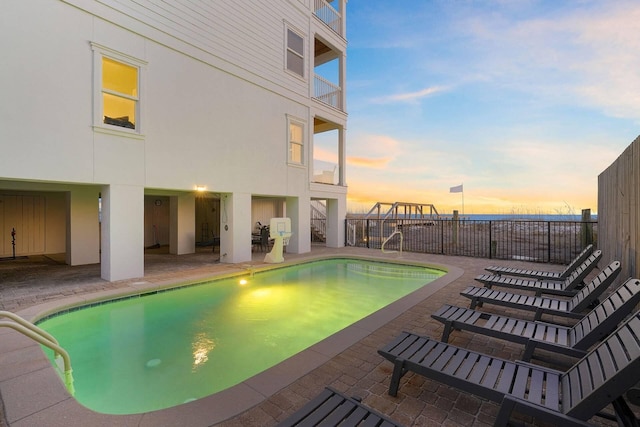 330 Tang O Mar Dr, Destin, FL 32550 - pool at dusk with a patio area and a fenced backyard