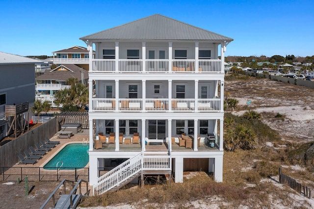 330 Tang O Mar Dr, Destin, FL 32550 - back of house with a balcony, a fenced backyard, a patio, a community pool, and an outdoor hangout area
