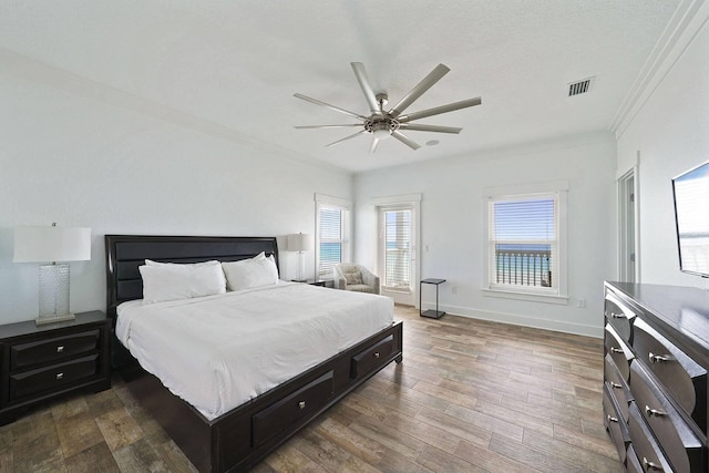 330 Tang O Mar Dr, Destin, FL 32550 - bedroom with crown molding, multiple windows, dark wood-type flooring, and a ceiling fan