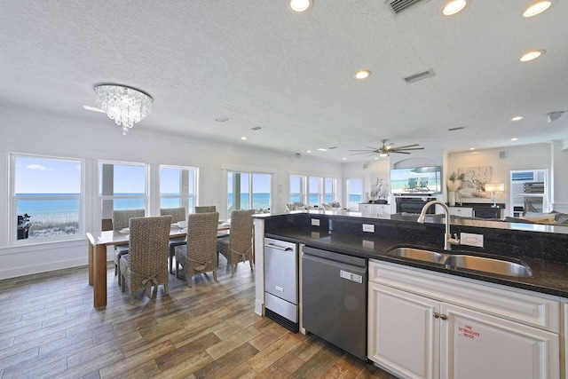 330 Tang O Mar Dr, Destin, FL 32550 - kitchen with stainless steel dishwasher, a textured ceiling, open floor plan, ceiling fan, and dark wood-type flooring