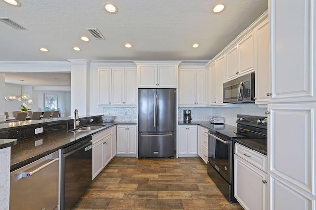 330 Tang O Mar Dr, Destin, FL 32550 - kitchen featuring appliances with stainless steel finishes, dark wood-type flooring, white cabinets, recessed lighting, and tasteful backsplash
