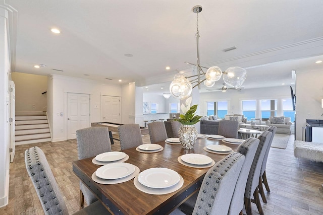 330 Tang O Mar Dr, Destin, FL 32550 - dining room with stairs, a chandelier, crown molding, wood finished floors, and recessed lighting
