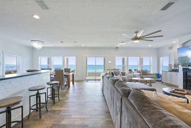330 Tang O Mar Dr, Destin, FL 32550 - living room featuring a textured ceiling, a ceiling fan, wood finished floors, and recessed lighting