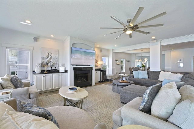 330 Tang O Mar Dr, Destin, FL 32550 - living area featuring a ceiling fan, a chandelier, ornamental molding, recessed lighting, and a fireplace