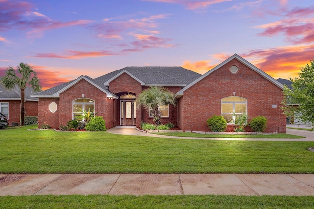 203 Landings Dr, Lynn Haven, FL 32444 - single story home with brick siding, a yard, and roof with shingles