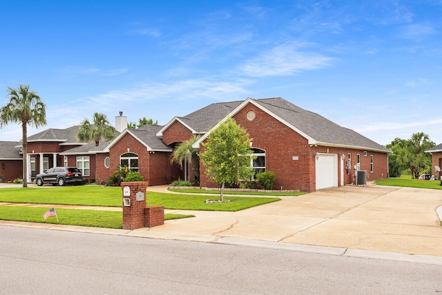 203 Landings Dr, Lynn Haven, FL 32444 - view of front of home with brick siding, concrete driveway, an attached garage, a front lawn, and a chimney