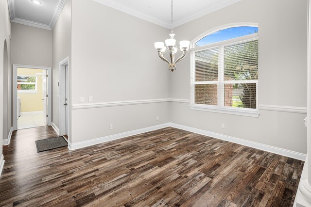 203 Landings Dr, Lynn Haven, FL 32444 - spare room featuring dark wood finished floors, baseboards, a chandelier, and crown molding