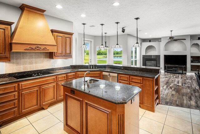 203 Landings Dr, Lynn Haven, FL 32444 - kitchen featuring black electric cooktop, custom range hood, a sink, stainless steel dishwasher, and a kitchen island with sink