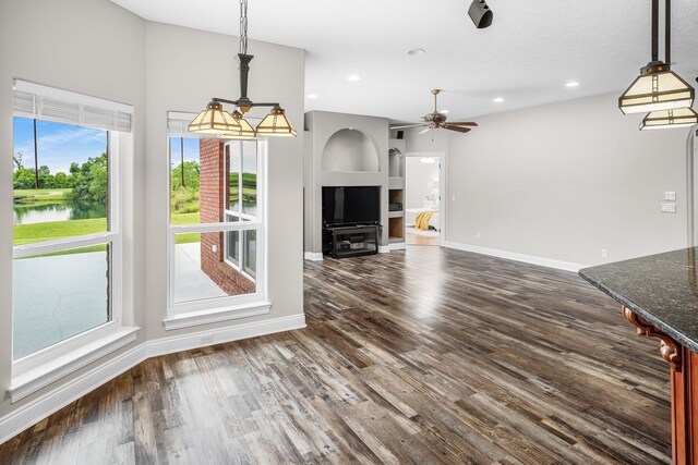 203 Landings Dr, Lynn Haven, FL 32444 - unfurnished living room with ceiling fan, baseboards, dark wood-style flooring, recessed lighting, and a water view