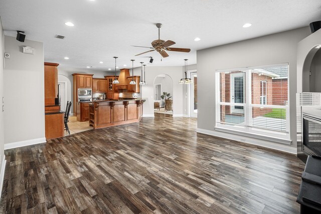203 Landings Dr, Lynn Haven, FL 32444 - unfurnished living room with arched walkways, ceiling fan, dark wood-type flooring, baseboards, and recessed lighting