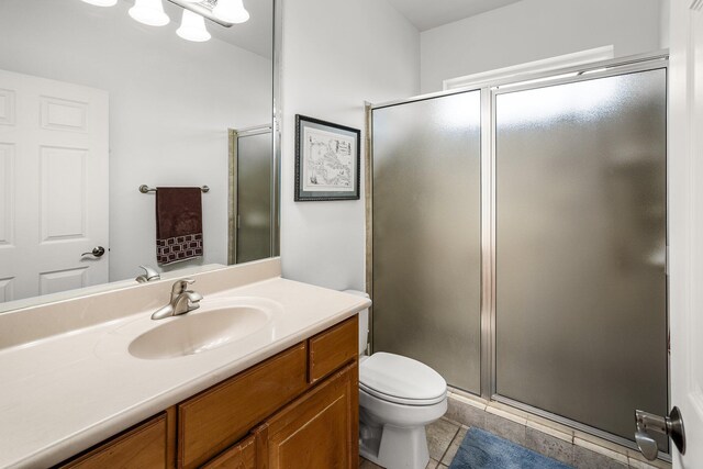 203 Landings Dr, Lynn Haven, FL 32444 - bathroom with vanity, a stall shower, toilet, and tile patterned flooring