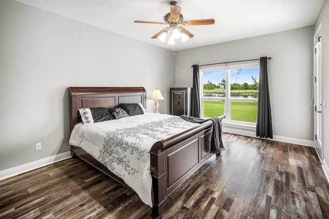 203 Landings Dr, Lynn Haven, FL 32444 - bedroom with baseboards, dark wood-style floors, a ceiling fan, and a water view