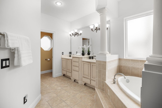 203 Landings Dr, Lynn Haven, FL 32444 - bathroom featuring ornate columns, double vanity, a garden tub, and tile patterned flooring